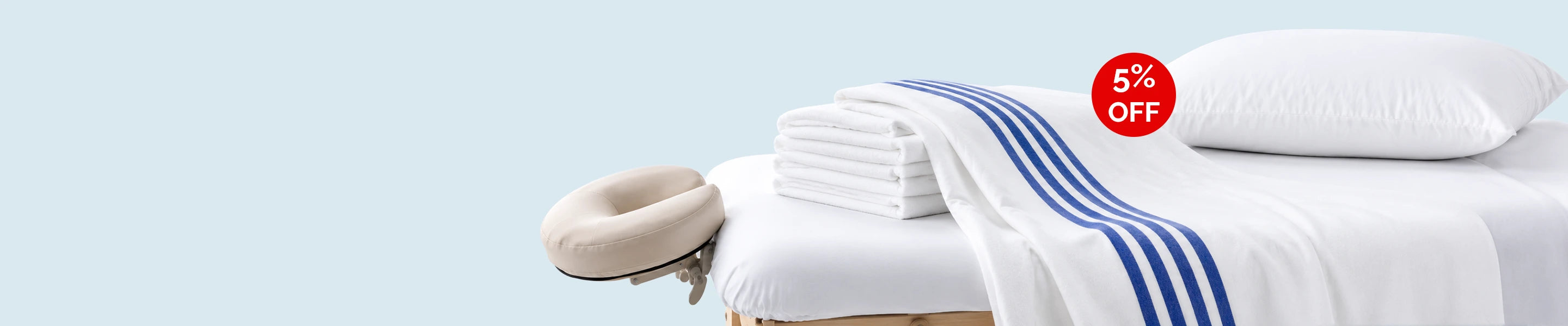 Clinical linens homepage banner featuring premium linen products arranged on a soft neutral background with a minimal aesthetic and spacious layout