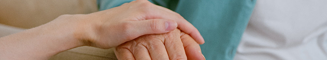 Caring hand over elderly hand