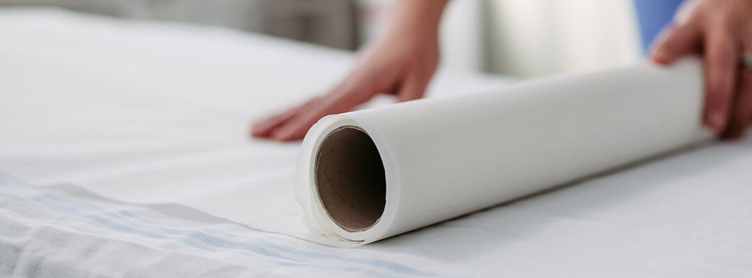 Nurse rolling out medical exam paper 