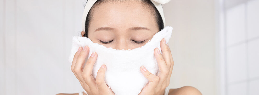 Woman using a white face towel