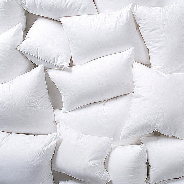 Stack of white pillows on a white background