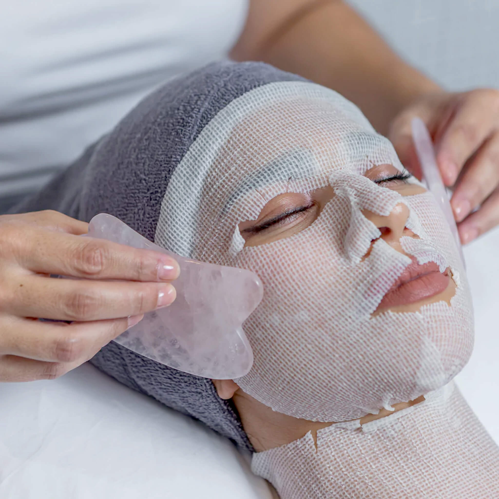 Precut Cotton Gauze Facial Sheets on models face and neck from WR Linens